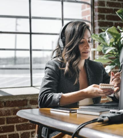 Female radio host broadcasting online in a studio